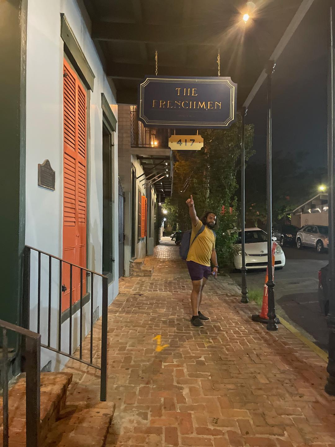 Andy Pointing at the Frenchman Inn Sign